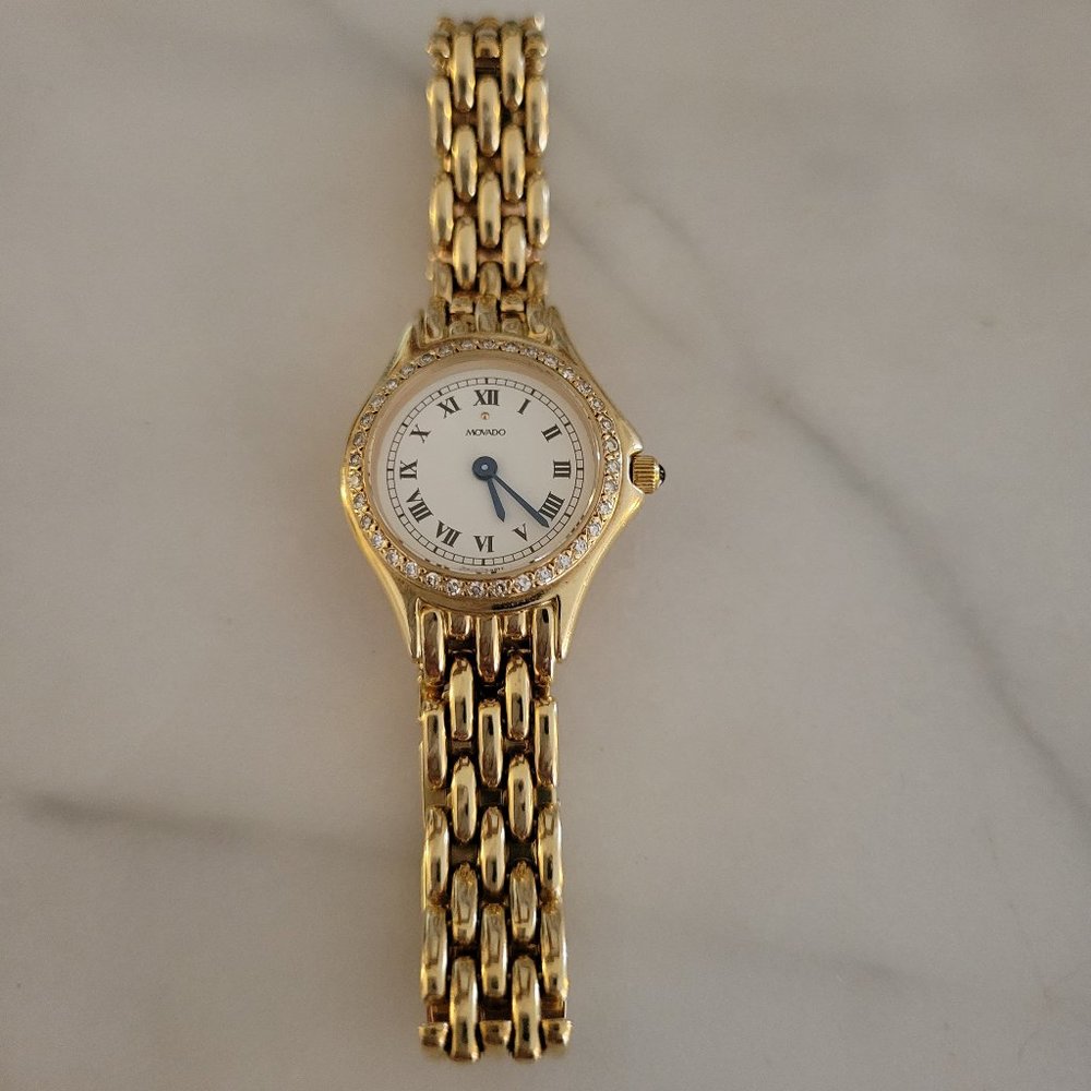 Women's 18 carat gold Movado watch with diamonds.